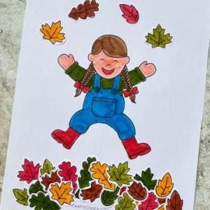 cut and paste craft with a child jumping in a pile of fall leaves