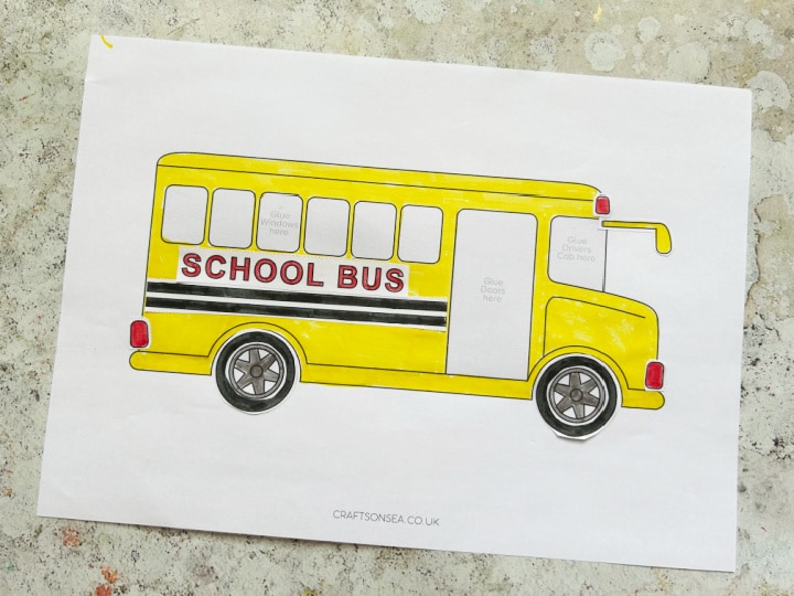 Gluing together the cut and paste school bus craft