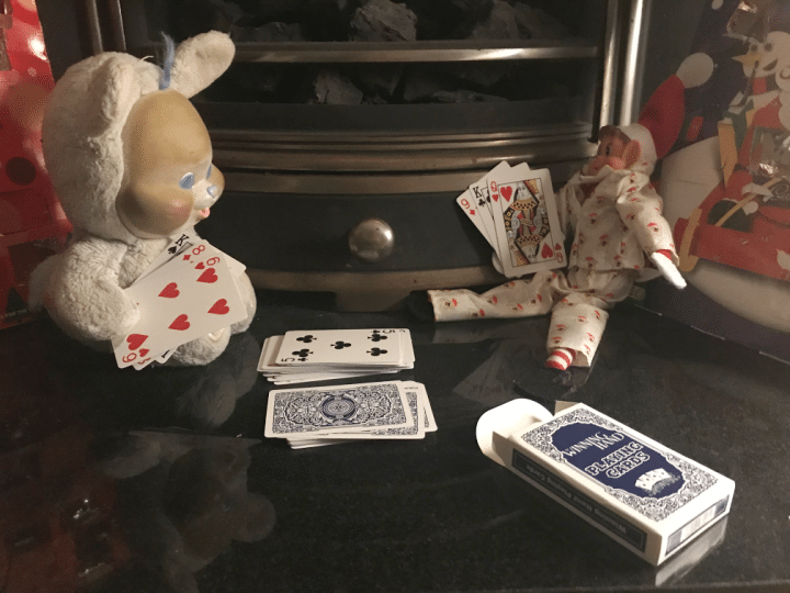 elf card game setup with toys