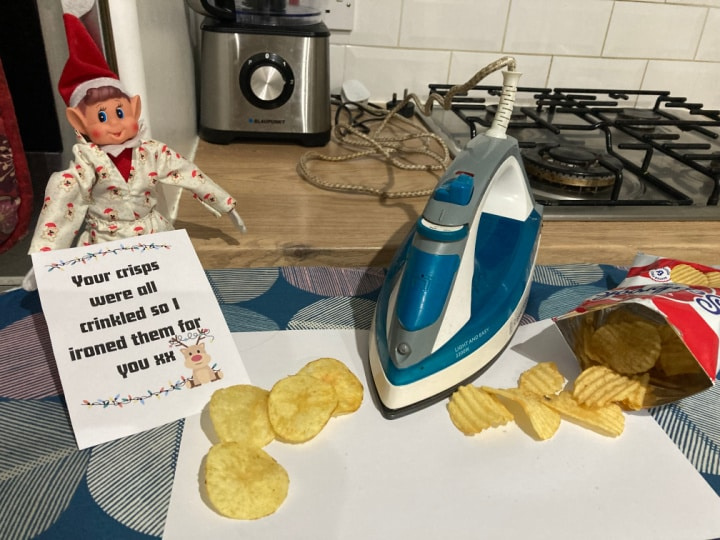 funny Christmas elf ironing crisps prank