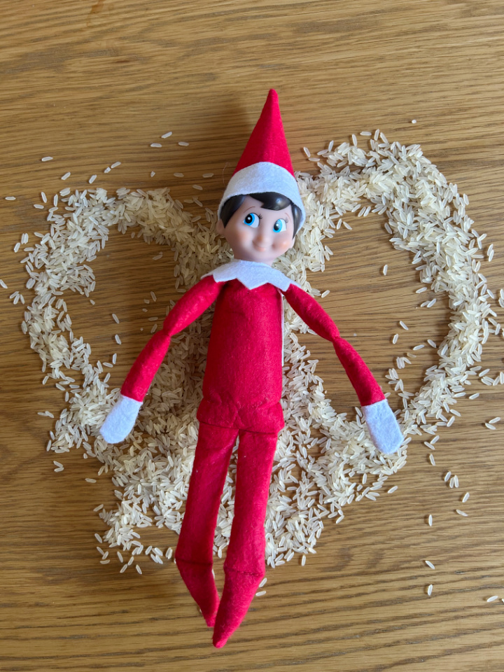 elf on the shelf making a snow angel with rice
