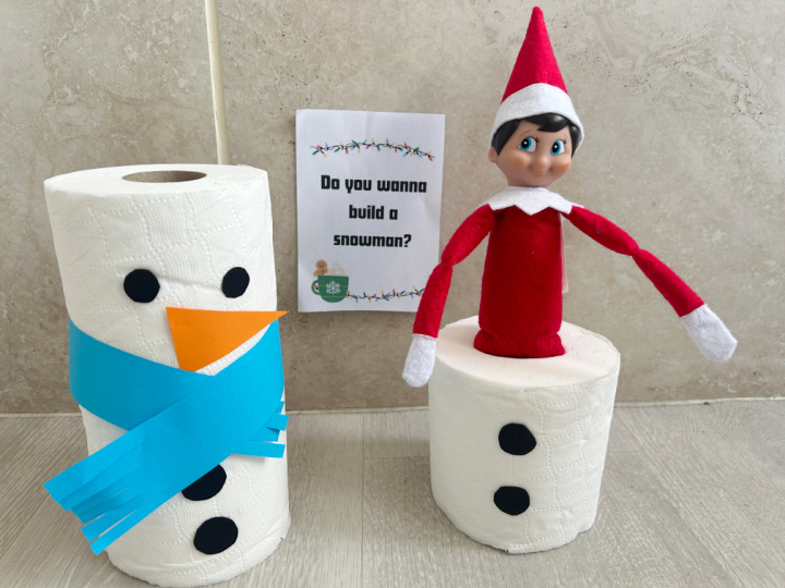 elf making a snowman from toilet rolls