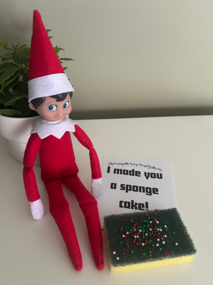 elf on the shelf making a pretend cake from a sponge