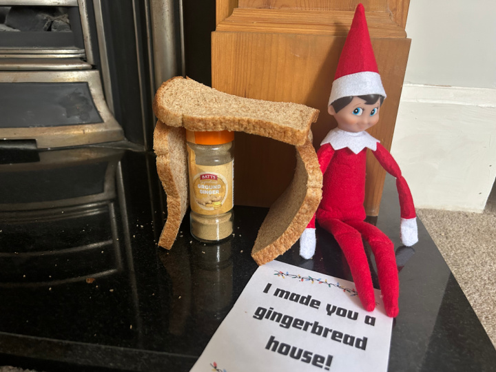 elf making a joke gingerbread house from bread