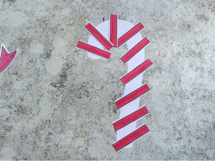 Gluing candy cane stripe pieces onto the main candy cane shape from printable template