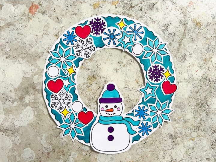 kids winter wreath craft with a snowman snowflakes and hearts