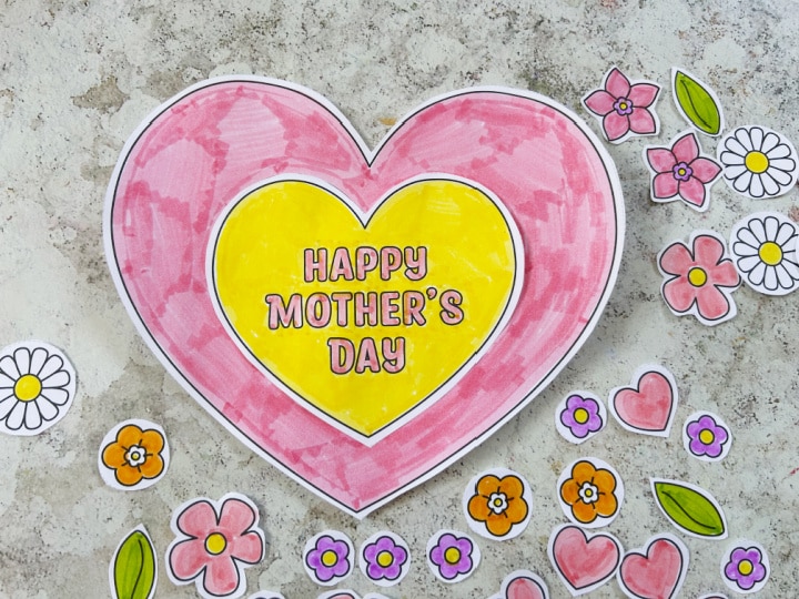 Gluing on heart shapes to make a Mother's Day craft