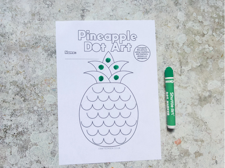 Fruit dot marker printable being decorated with dot markers