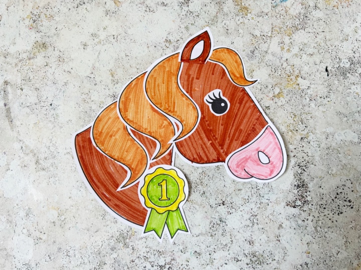 Finished horse cut and paste craft with mane and rosette