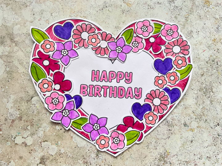 inished printable birthday wreath craft with colorful flowers, hearts and Happy Birthday decoration