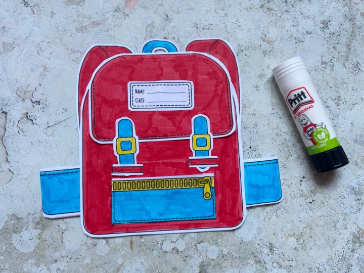 Gluing paper pockets onto the school backpack craft