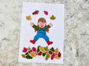 printable craft of a child jumping in a pile of fall leaves