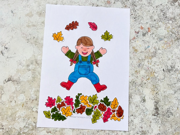 printable craft of a child jumping in a pile of fall leaves