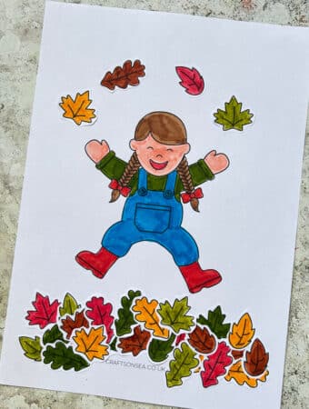 fall leaves cut and paste craft showing a child jumping in leaves