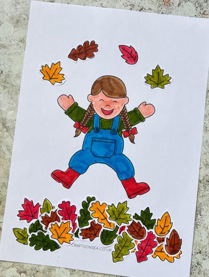 fall leaves cut and paste craft showing a child jumping in leaves