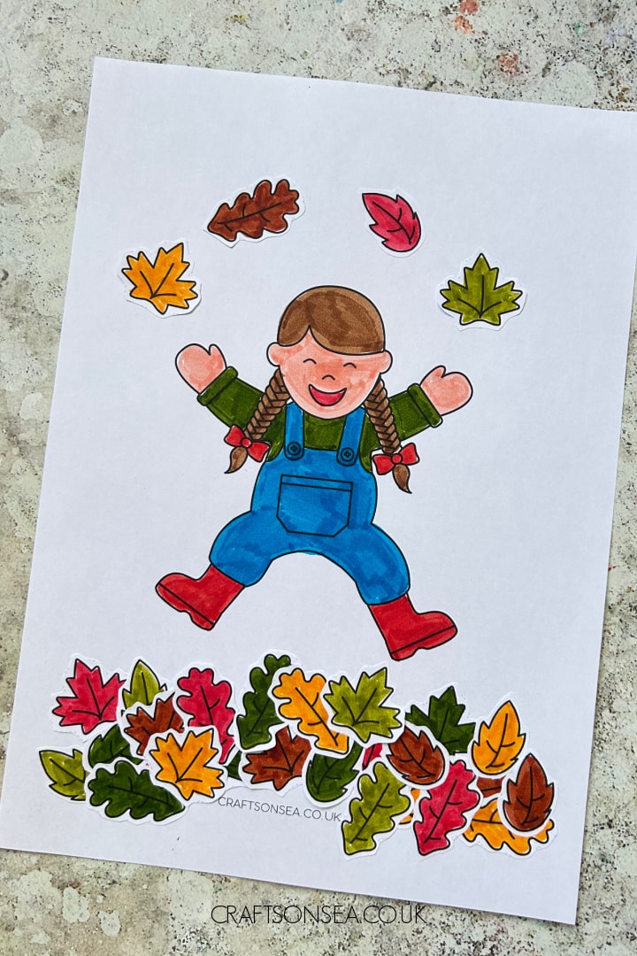 fall leaves cut and paste craft showing a child jumping in leaves