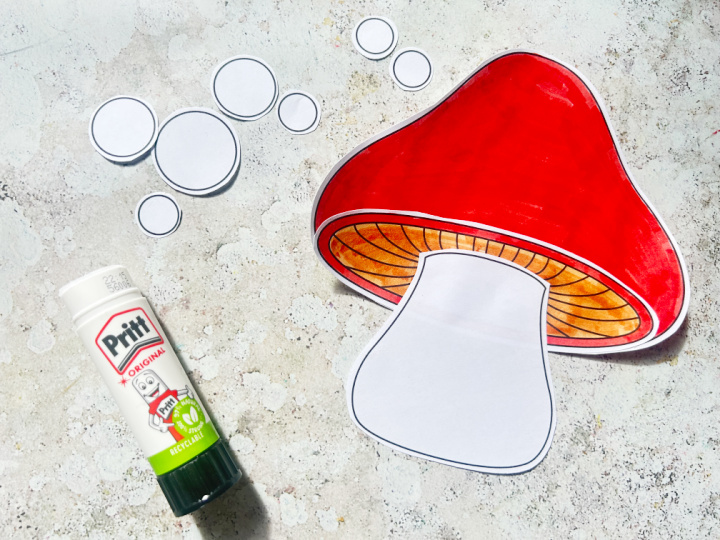 Gluing together the cap, gills and stalk of the toadstool craft