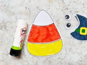 assembling the pieces of a candy corn cut and paste craft