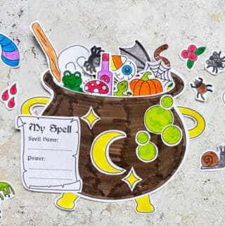completed cauldron craft filled with spell ingredients including a paper frog, pumpkin and spider
