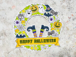 Halloween wreath craft with candy corn, ghost, pumpkin and bat decorations