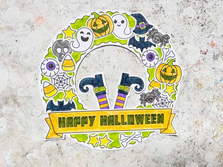 Halloween wreath craft with candy corn, ghost, pumpkin and bat decorations