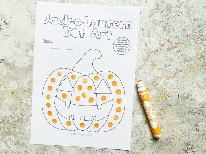 jack o'lantern pumpkin dot marker activity sheet being colored in with dot a dot markers
