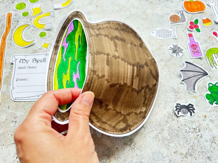 gluing a paper cauldron together to make a pocket