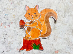 finished squirrel craft with an acorn and tree stump