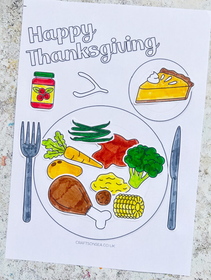 Thanksgiving dinner plate craft for kids with turkey, broccoli, cranberry sauce, sweet potato and pumpkin pie made with a free printable
