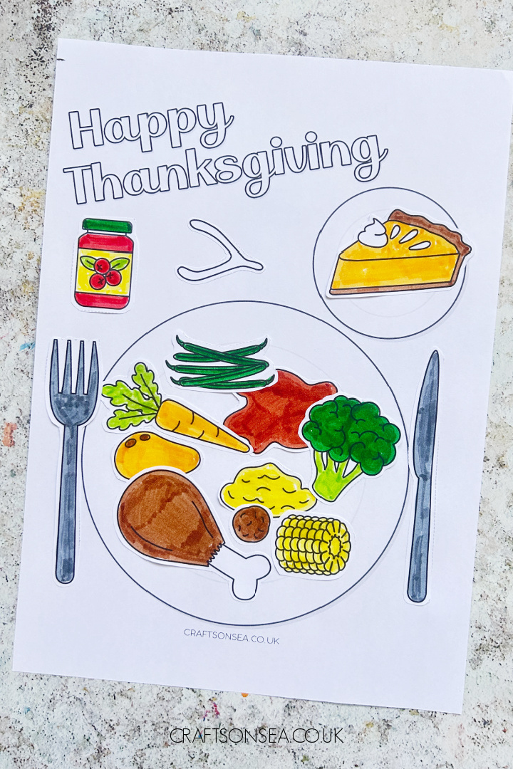 Thanksgiving dinner plate craft for kids with turkey, broccoli, cranberry sauce, sweet potato and pumpkin pie made with a free printable